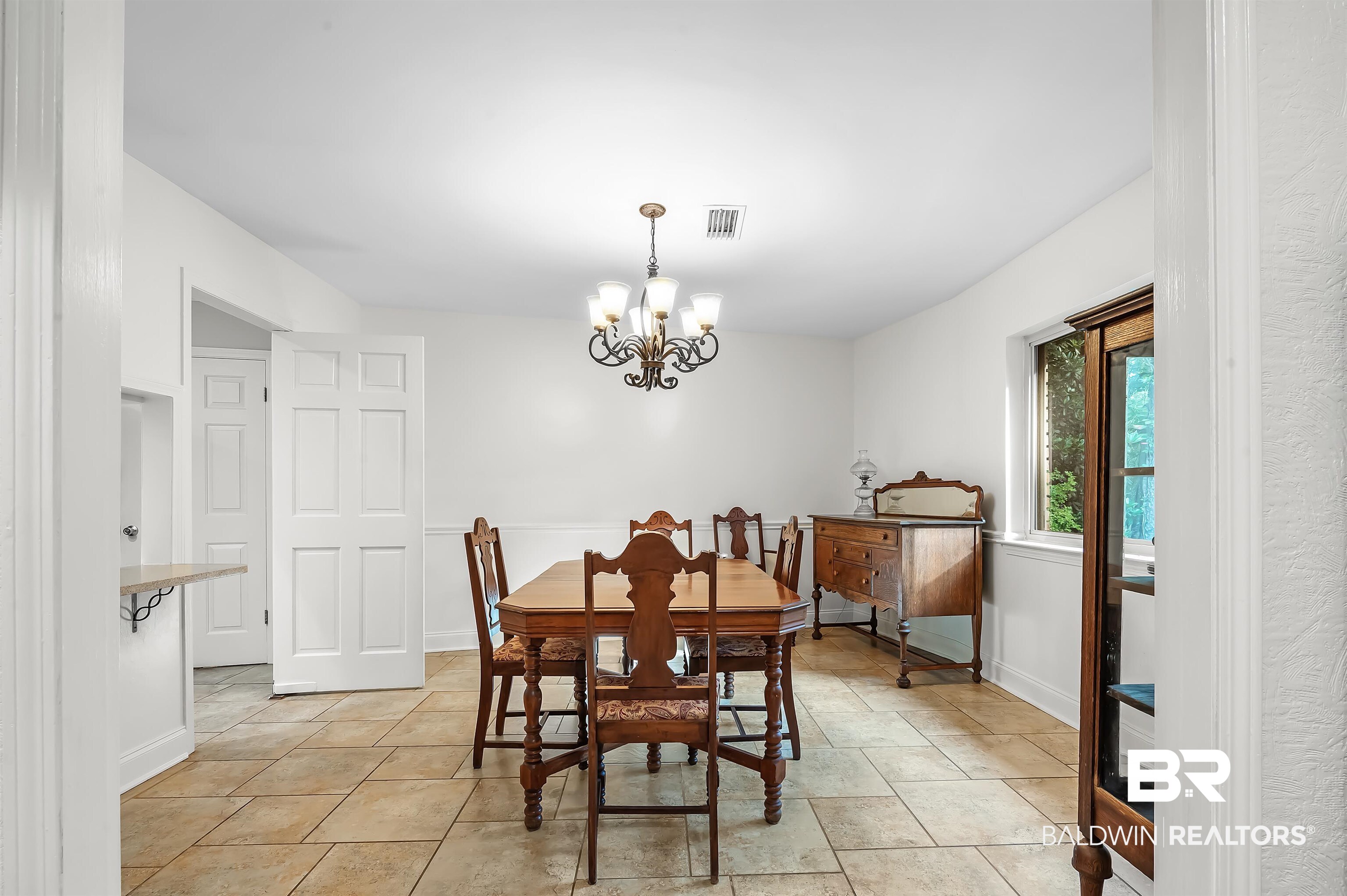 104 James Circle Daphne, AL 36526 - Photo 35 of 62 Tiled dining area featuring a notable chandelier