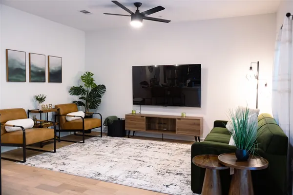 a living room with furniture and a flat screen tv