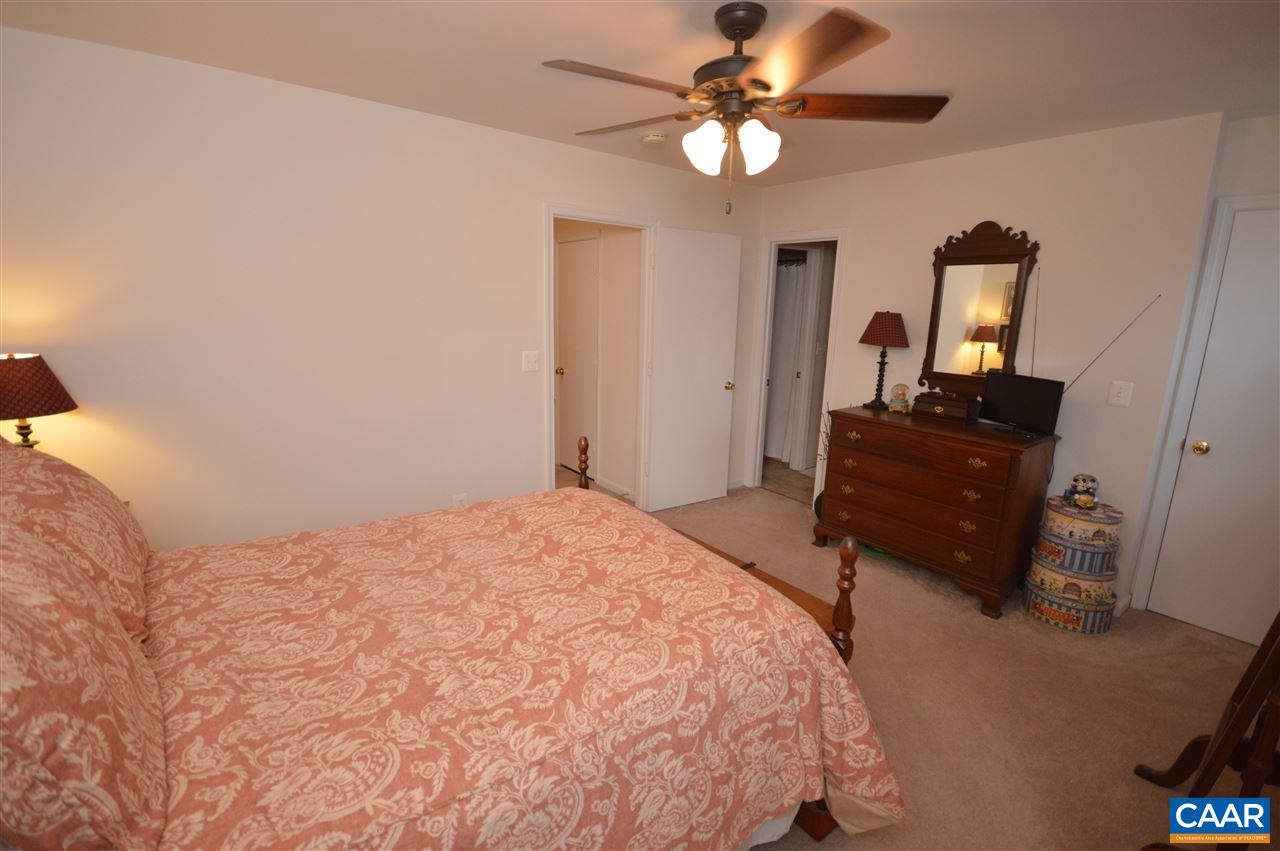 1574 Cool Spring Road Charlottesville, VA 22901 - Photo 15 of 23 a bedroom with a bed and a chandelier