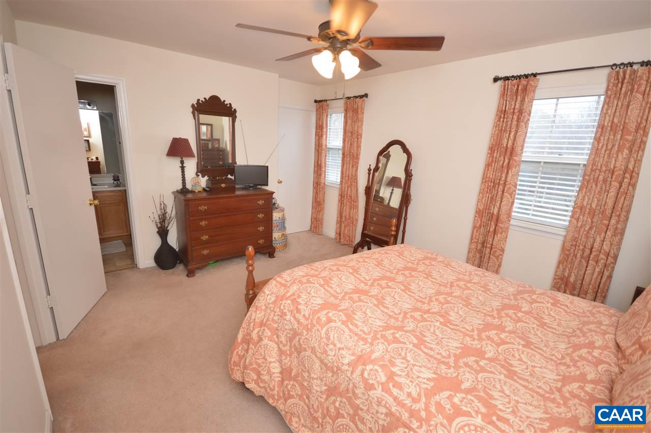 1574 Cool Spring Road Charlottesville, VA 22901 - Photo 16 of 23 a bedroom with a bed and a chandelier