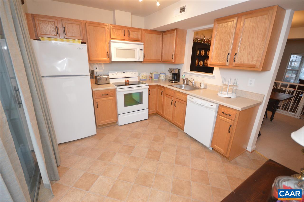 1574 Cool Spring Road Charlottesville, VA 22901 - Photo 10 of 23 a kitchen with white cabinets and white appliances