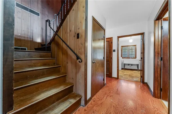 a view of entryway and hall with wooden floor