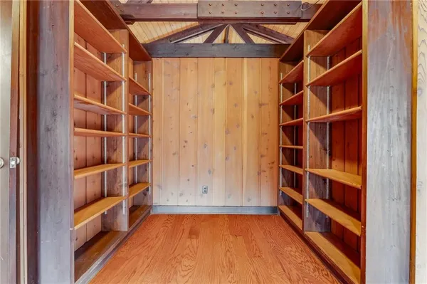 a view of walk in closet with empty racks