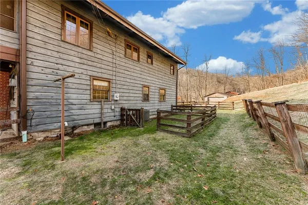 a view of a house with backyard and sitting area