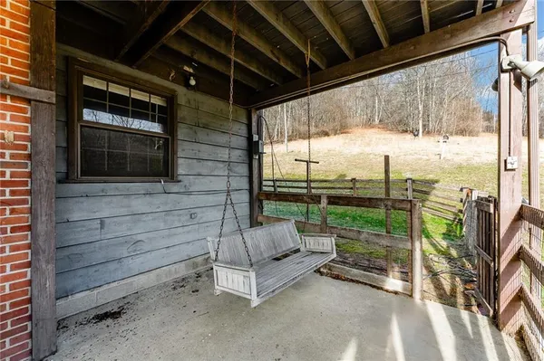 a view of a porch with furniture and floor to ceiling window