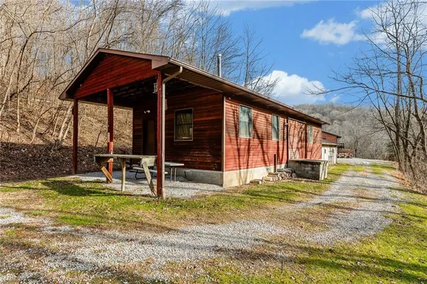 a view of a house with backyard and sitting area