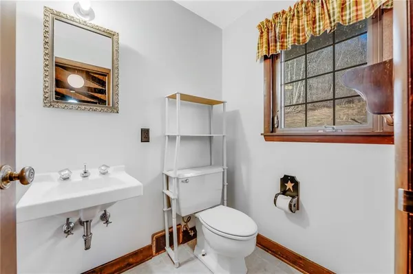 a bathroom with a sink mirror and toilet