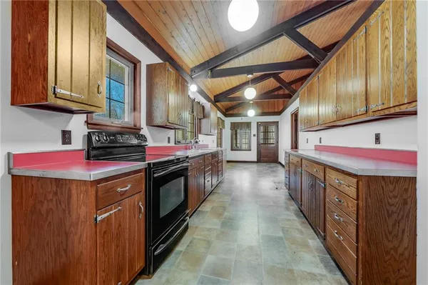 a kitchen with stainless steel appliances granite countertop a stove and cabinets