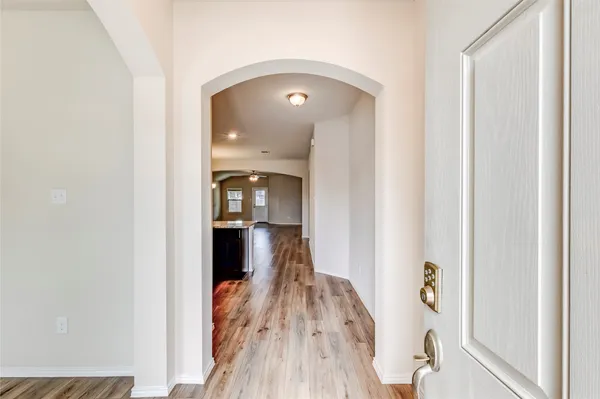 a view of a hallway view with wooden floor and staircase