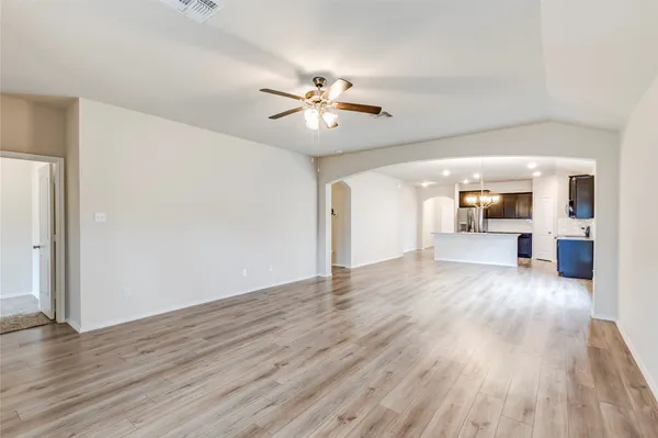 a view of a livingroom with wooden floor and a ceiling fan