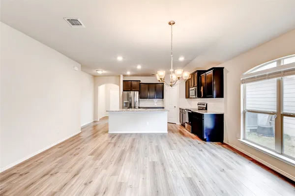 a view of a kitchen with cabinets and wooden floor
