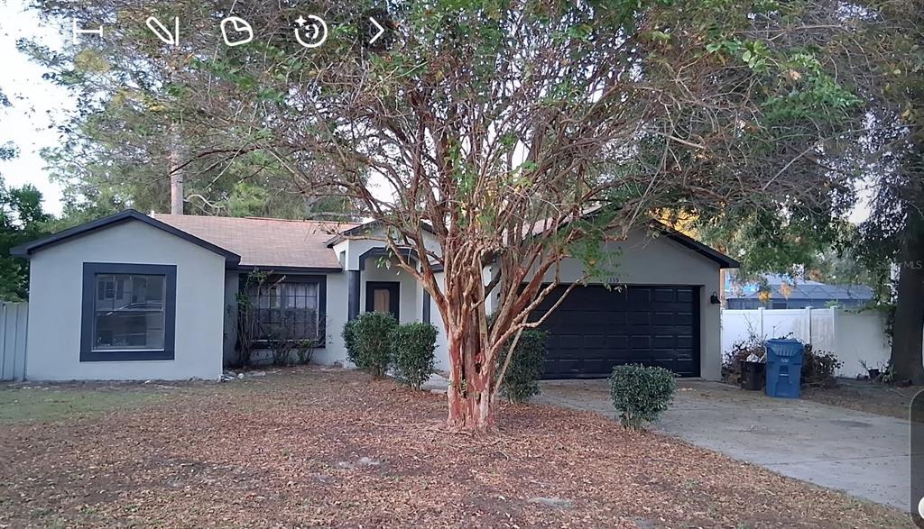 11339 Dean Street Spring Hill, FL 34608 - Photo 1 of 33 a house with a tree in front of it