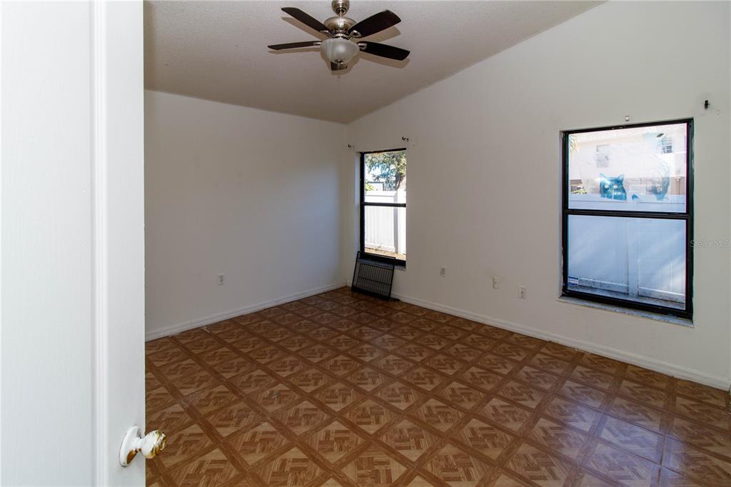 11339 Dean Street Spring Hill, FL 34608 - Photo 11 of 33 a view of an empty room with window and wooden floor
