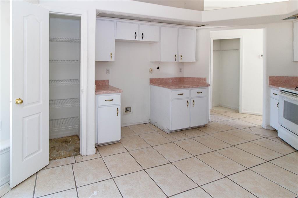 11339 Dean Street Spring Hill, FL 34608 - Photo 24 of 33 a kitchen with white cabinets and a sink