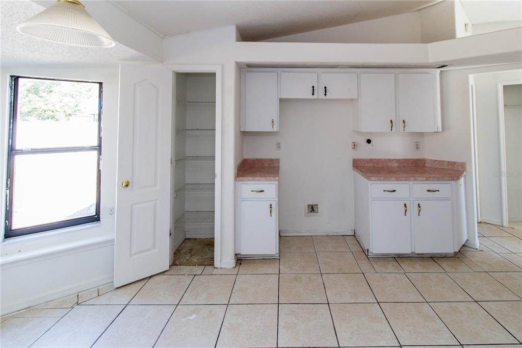 11339 Dean Street Spring Hill, FL 34608 - Photo 25 of 33 a kitchen with a cabinets and window