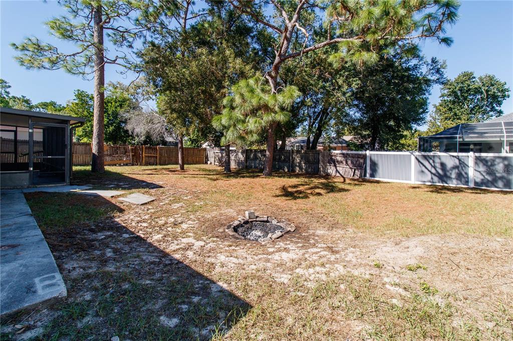 11339 Dean Street Spring Hill, FL 34608 - Photo 31 of 33 a view of a yard with a tree