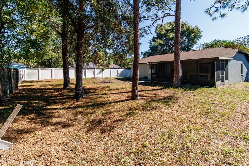11339 Dean Street Spring Hill, FL 34608 - Photo 5 of 33 a view of a house with a yard covered in snow