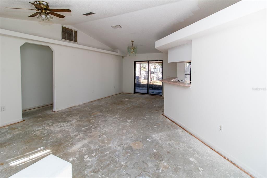 11339 Dean Street Spring Hill, FL 34608 - Photo 6 of 33 a view of a big room with windows and chandelier fan
