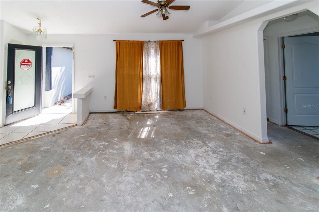 11339 Dean Street Spring Hill, FL 34608 - Photo 8 of 33 an empty room with window and a ceiling fan