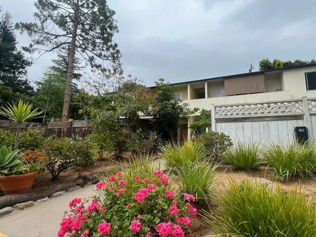 a flower garden in front of a house