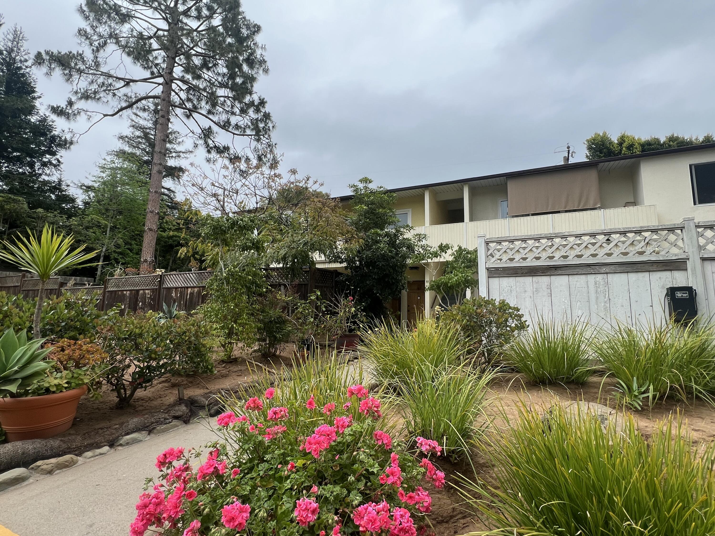 a flower garden in front of a house