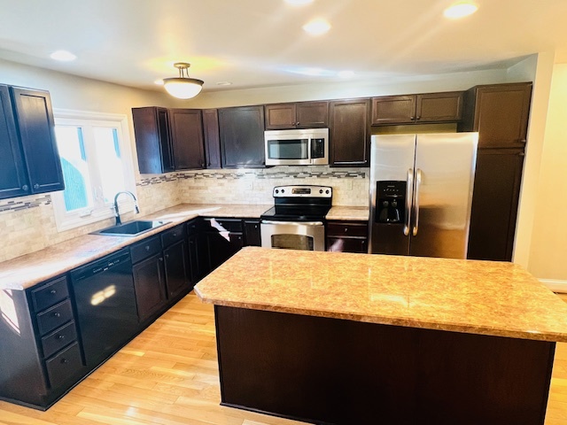 323 South Towanda Avenue, Unit 4 Normal, IL 61761 - Photo 10 of 33 a kitchen with stainless steel appliances kitchen island granite countertop a sink refrigerator and microwave