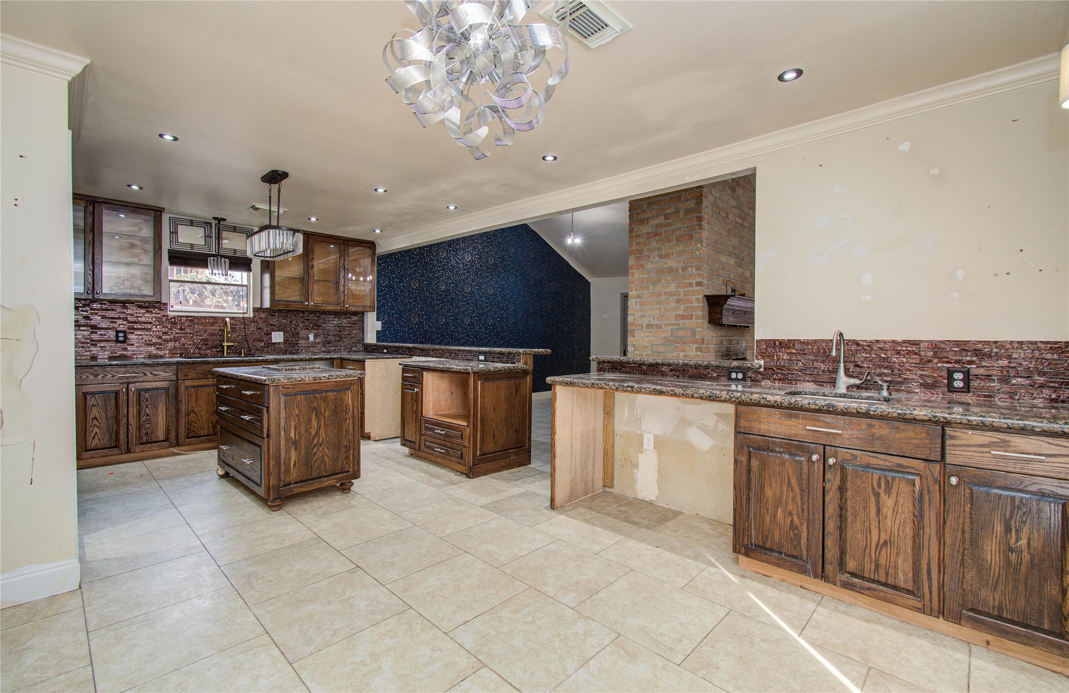 2006 Waterelm Drive Houston, TX 77084 - Photo 11 of 27 This inviting breakfast area blends rustic charm with modern elegance, featuring rich wooden cabinetry, sleek granite countertops, and stylish lighting, perfect for morning gatherings.
