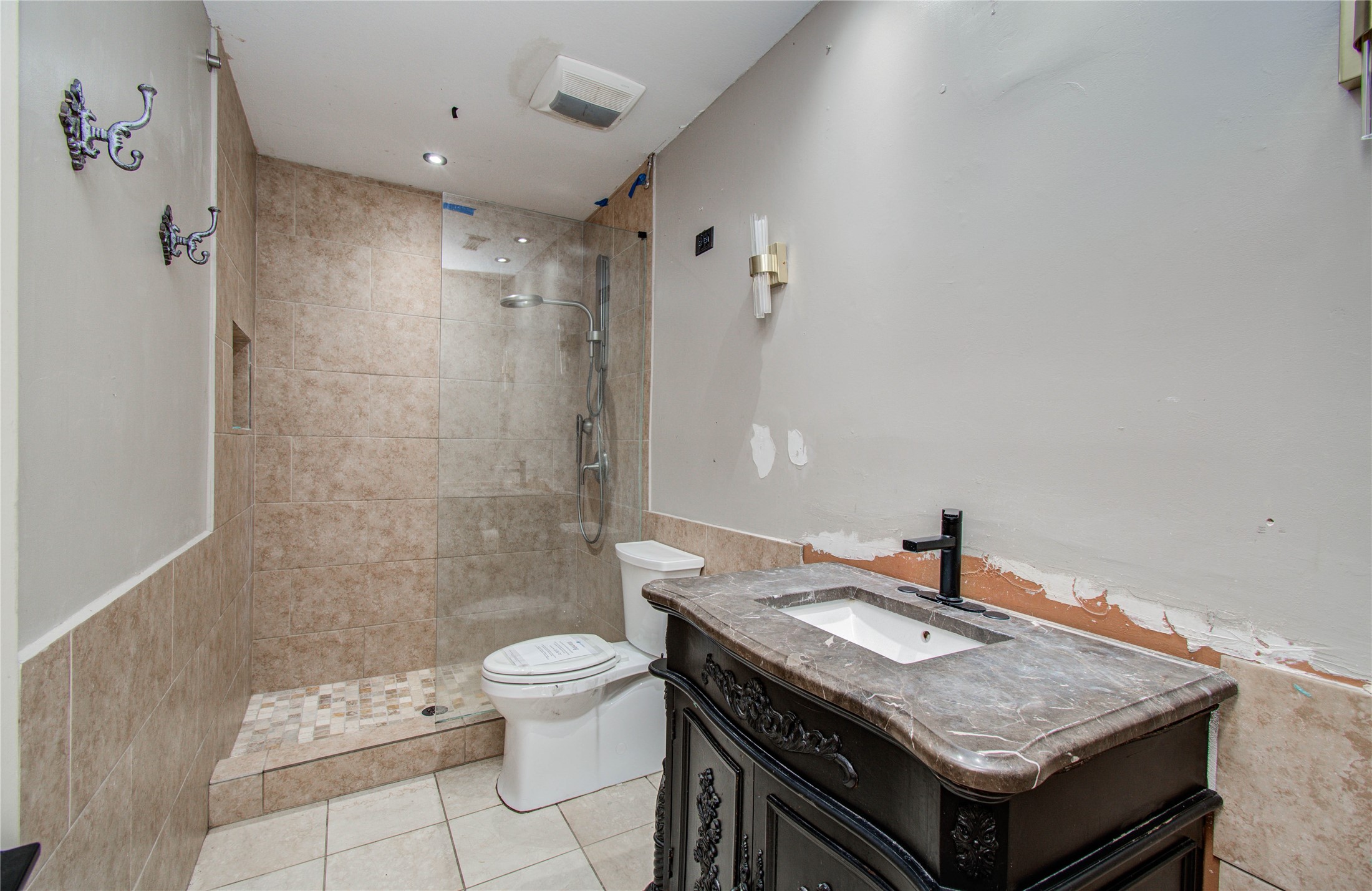 2006 Waterelm Drive Houston, TX 77084 - Photo 18 of 27 This bathroom offers a blend of elegance and potential, featuring a spacious tiled shower and a stylish vanity with a sleek black faucet, inviting your personal touch to complete the space.