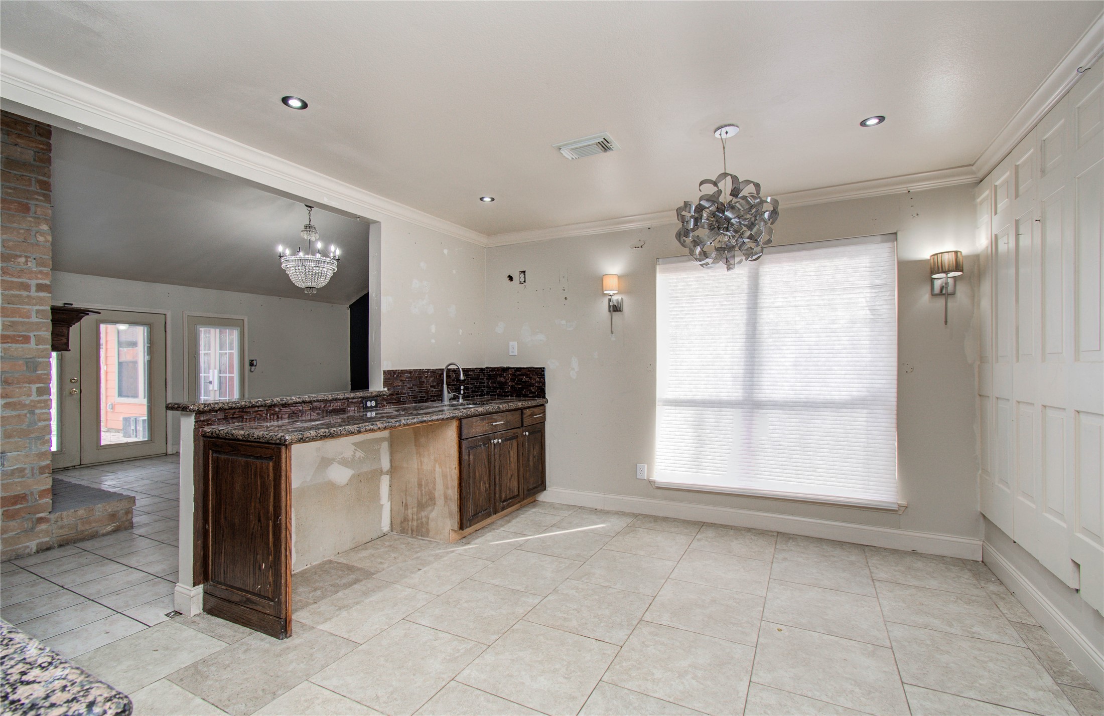 2006 Waterelm Drive Houston, TX 77084 - Photo 10 of 27 This inviting breakfast area boasts abundant natural light and a stylish chandelier, providing the perfect cozy nook to start your day.