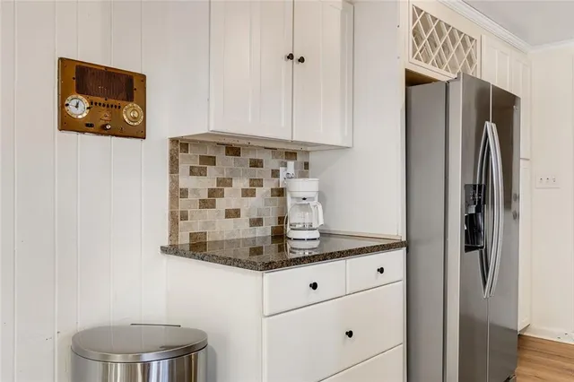 a kitchen with stainless steel appliances granite countertop a refrigerator and a stove top oven