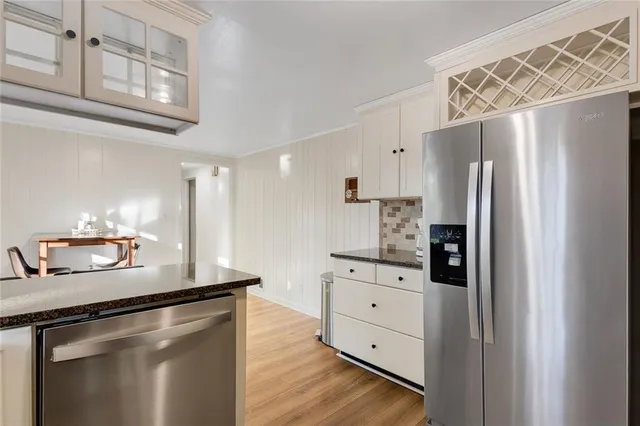 a kitchen with stainless steel appliances a refrigerator and a stove