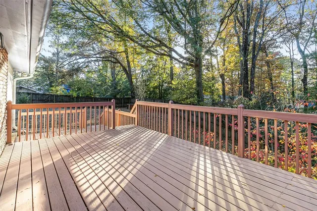 a balcony with wooden floor and fence