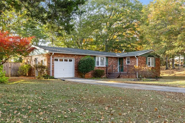 a front view of a house with yard patio and green space