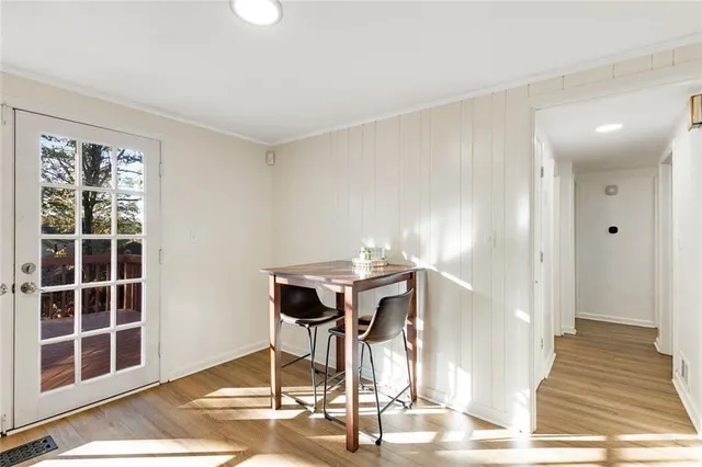 a view of a room with a dining table and chairs