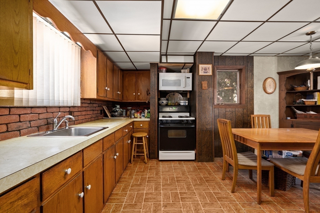 288 Cedar Street Somerville, MA 02145 - Photo 13 of 23 a kitchen with stainless steel appliances granite countertop a sink window and cabinets