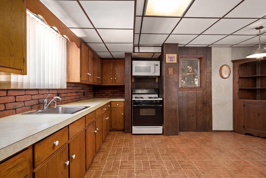 288 Cedar Street Somerville, MA 02145 - Photo 15 of 23 a kitchen with stainless steel appliances granite countertop a refrigerator and a sink