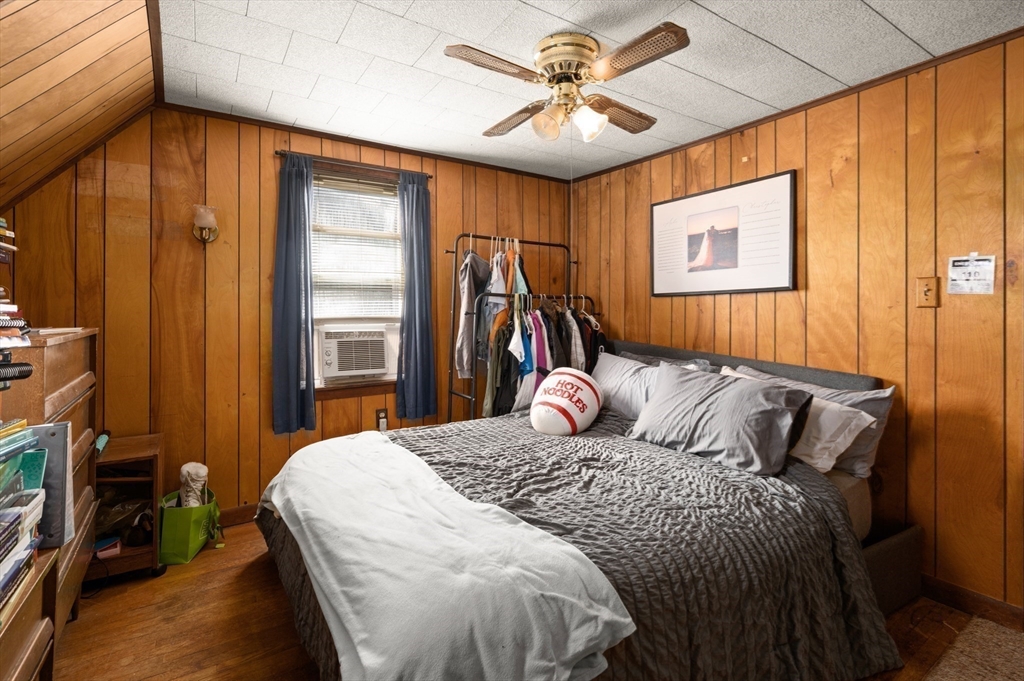 288 Cedar Street Somerville, MA 02145 - Photo 17 of 23 a bedroom with a bed and a chandelier