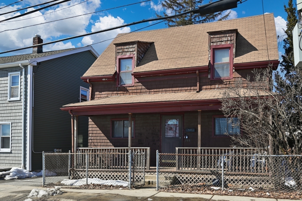 288 Cedar Street Somerville, MA 02145 - Photo 2 of 23 a view of a house with a small yard and wooden fence