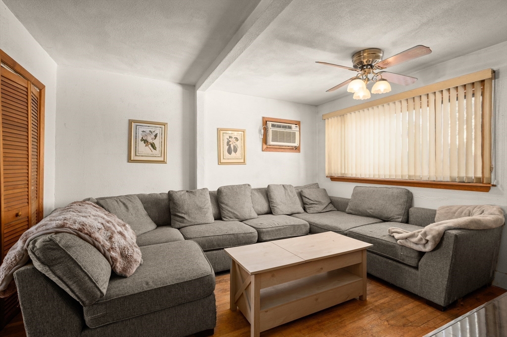 288 Cedar Street Somerville, MA 02145 - Photo 3 of 23 a living room with furniture and a chandelier