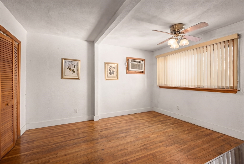 288 Cedar Street Somerville, MA 02145 - Photo 4 of 23 a view of empty room with wooden floor and fan