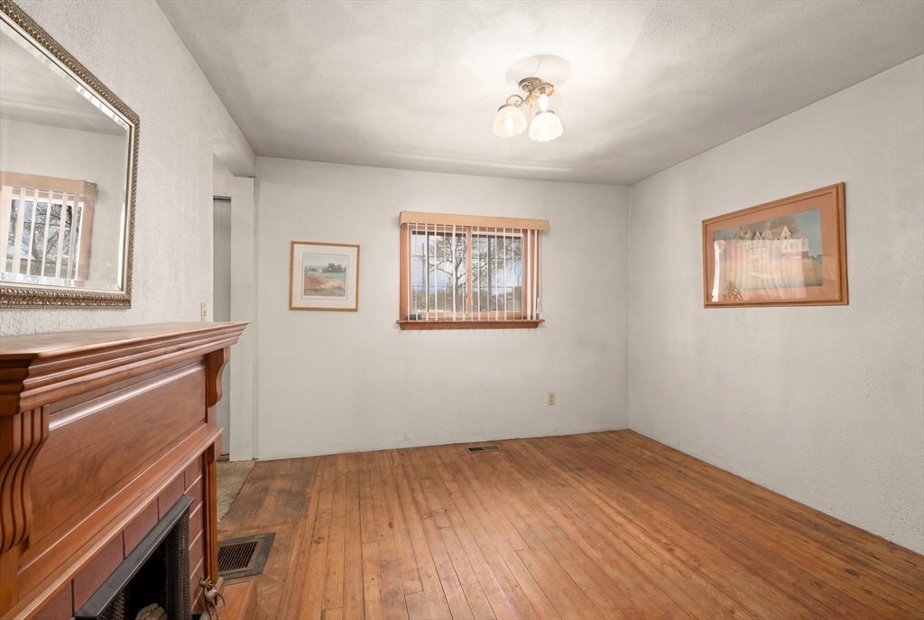288 Cedar Street Somerville, MA 02145 - Photo 5 of 23 a view of empty room with wooden floor and fan