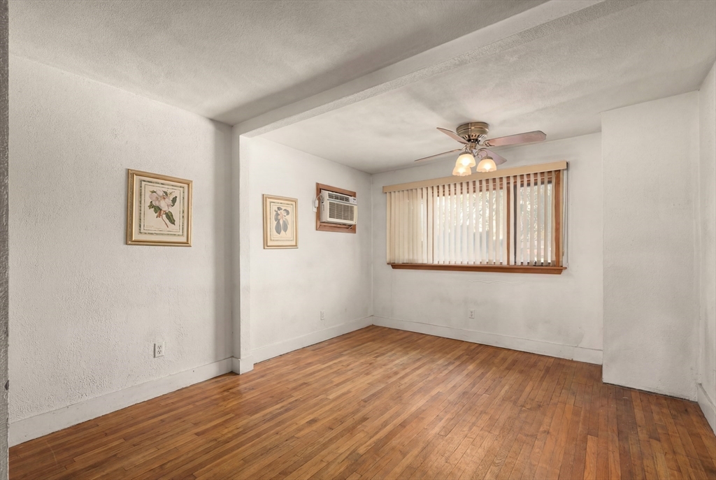 288 Cedar Street Somerville, MA 02145 - Photo 9 of 23 a view of an empty room with wooden floor and a window