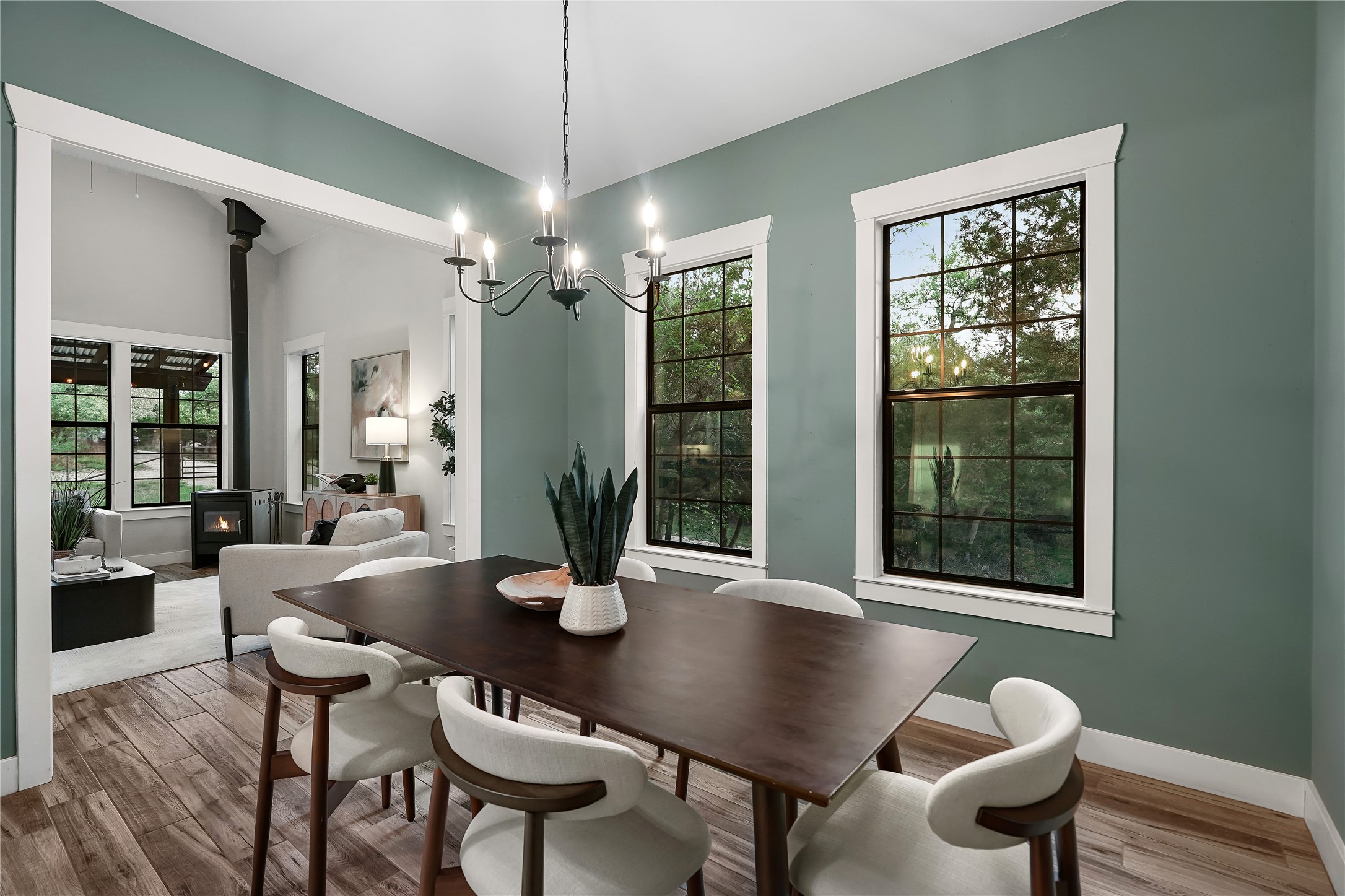 786 Beauchamp Road Dripping Springs, TX 78620 - Photo 14 of 40 Dining area with hardwood style flooring, a stylish chandelier, and two windows providing natural light