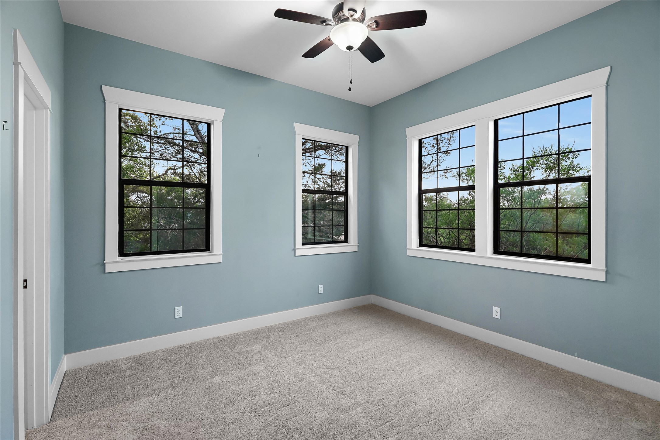 786 Beauchamp Road Dripping Springs, TX 78620 - Photo 21 of 40 This room features light blue walls, gray carpet, and a ceiling fan