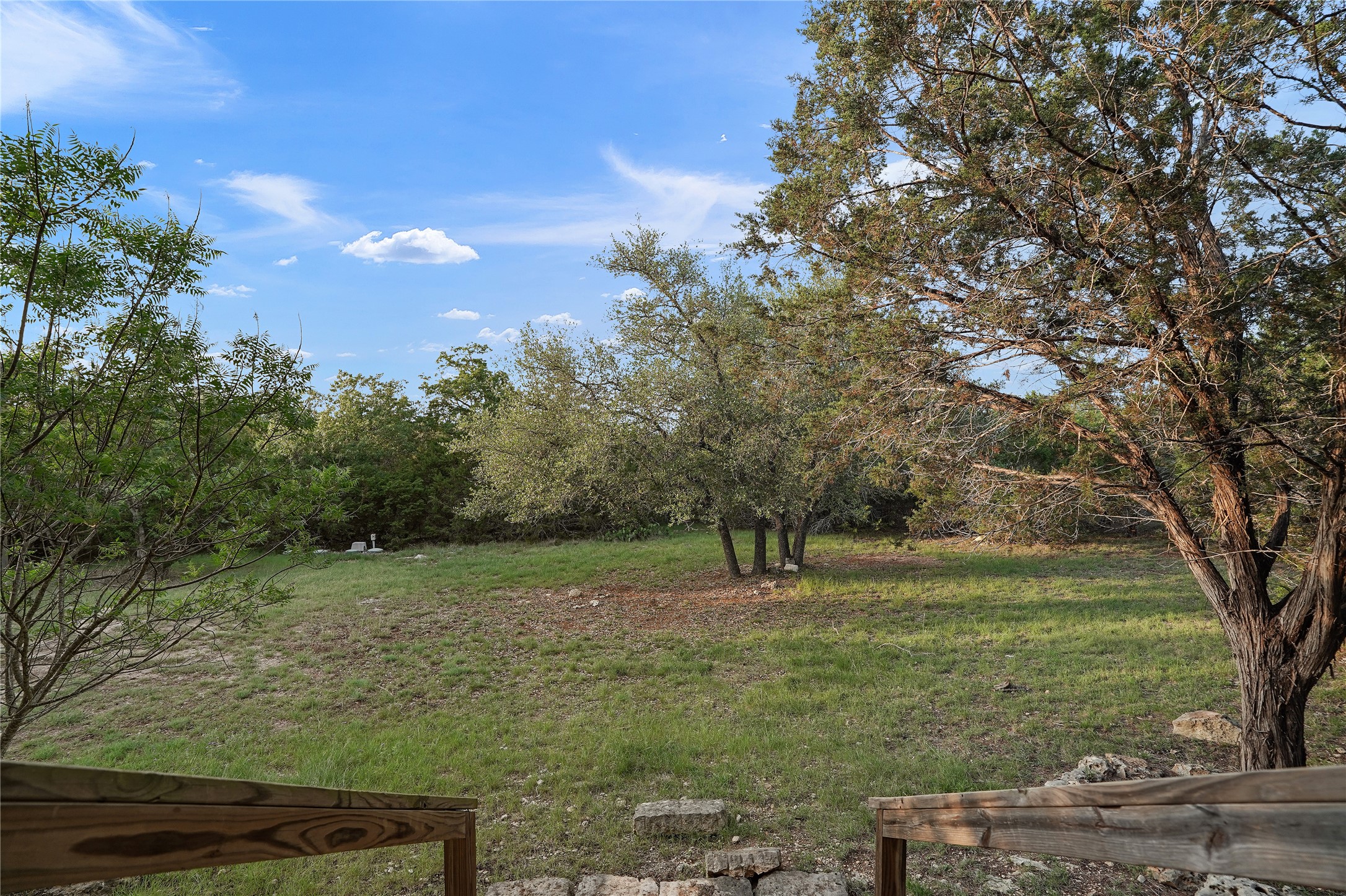 786 Beauchamp Road Dripping Springs, TX 78620 - Photo 26 of 40 The property features a spacious yard with mature trees and a natural, verdant landscape