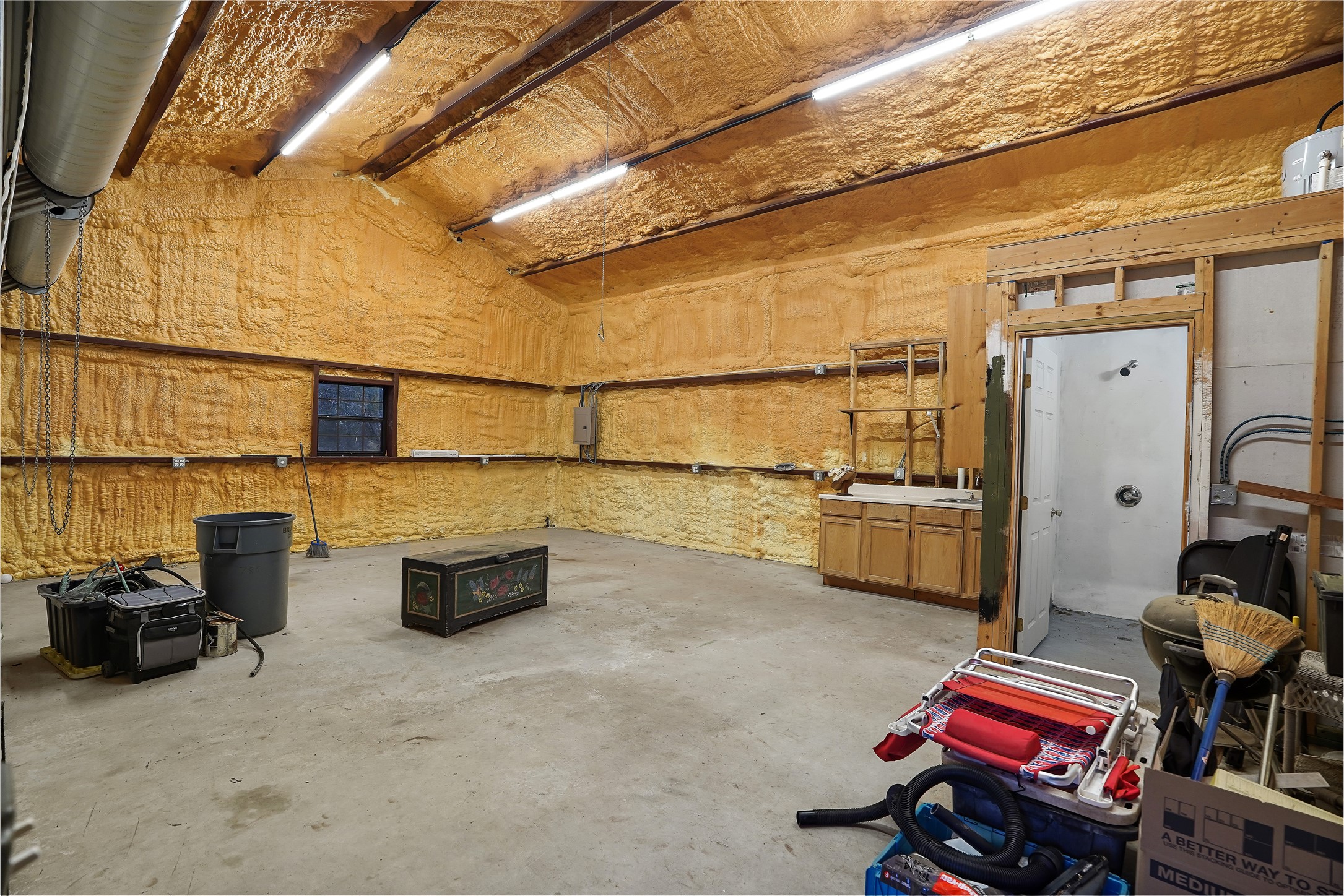 786 Beauchamp Road Dripping Springs, TX 78620 - Photo 30 of 40 The property features a spacious room with concrete flooring, exposed ceiling beams, and insulated walls and ceiling
