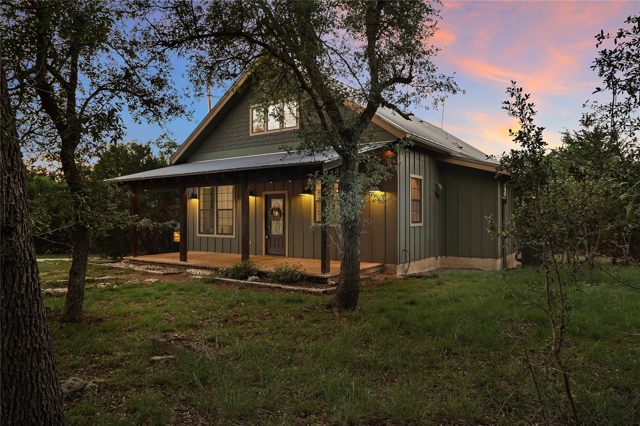 786 Beauchamp Road Dripping Springs, TX 78620 - Photo 3 of 40 This property features a welcoming covered porch with visible wooden support pillars and exterior lighting