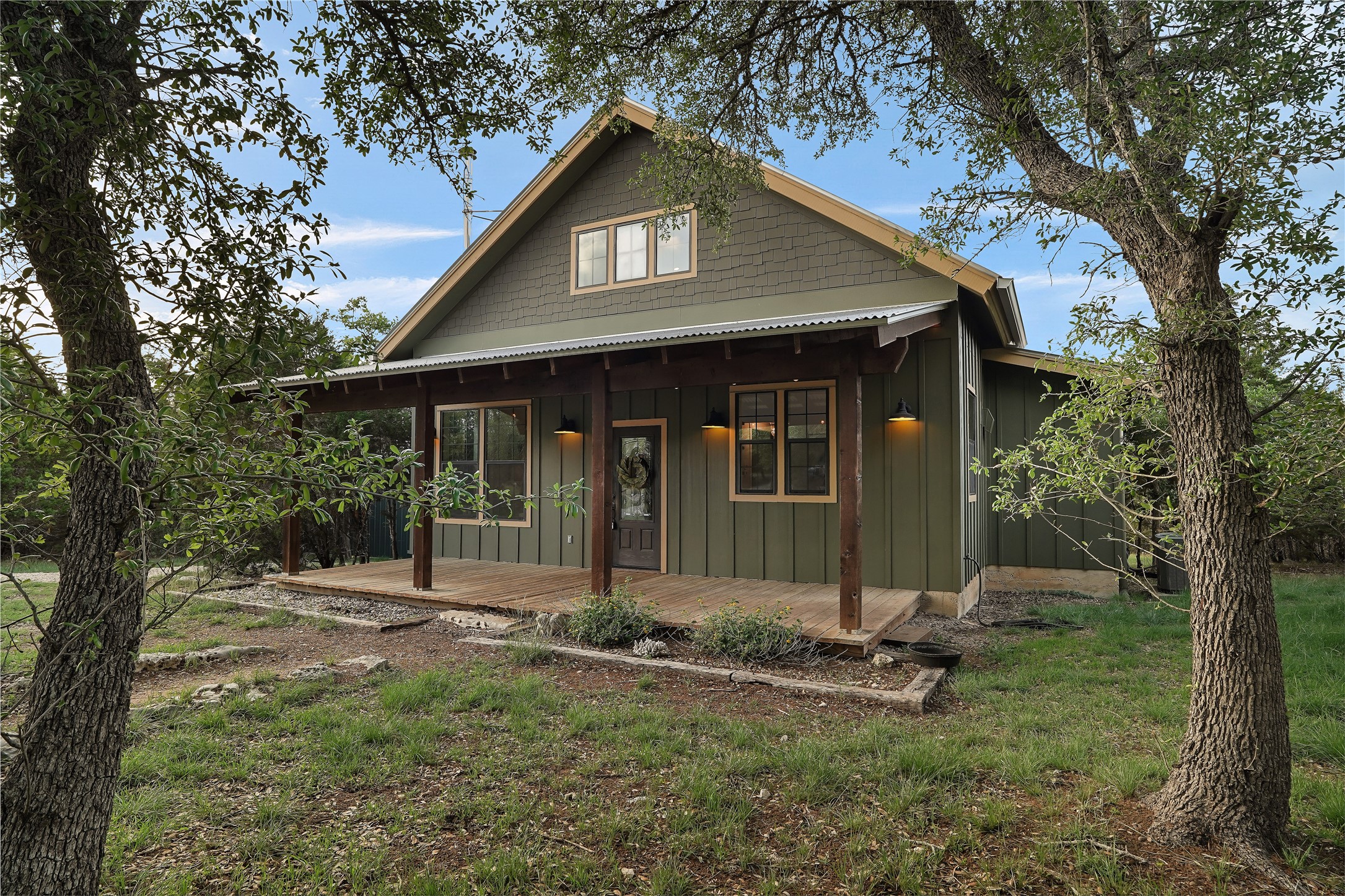 786 Beauchamp Road Dripping Springs, TX 78620 - Photo 33 of 40 The property features a charming exterior with a covered wooden porch and shake siding on the upper facade