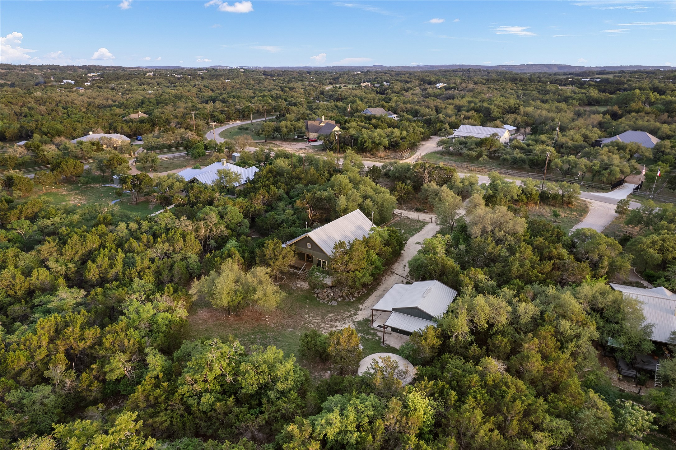 786 Beauchamp Road Dripping Springs, TX 78620 - Photo 39 of 40 Aerial view showcasing the property nestled amongst extensive mature trees, offering a private setting