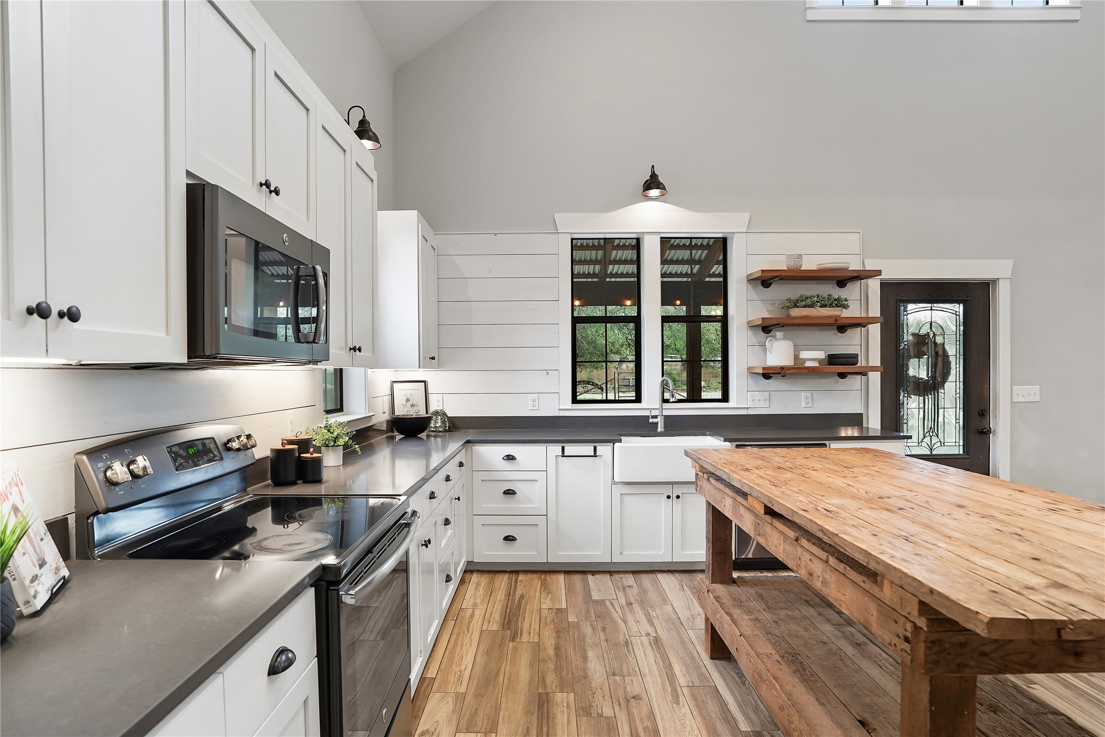 786 Beauchamp Road Dripping Springs, TX 78620 - Photo 5 of 40 The kitchen features white cabinetry, dark countertops, and stainless steel appliances
